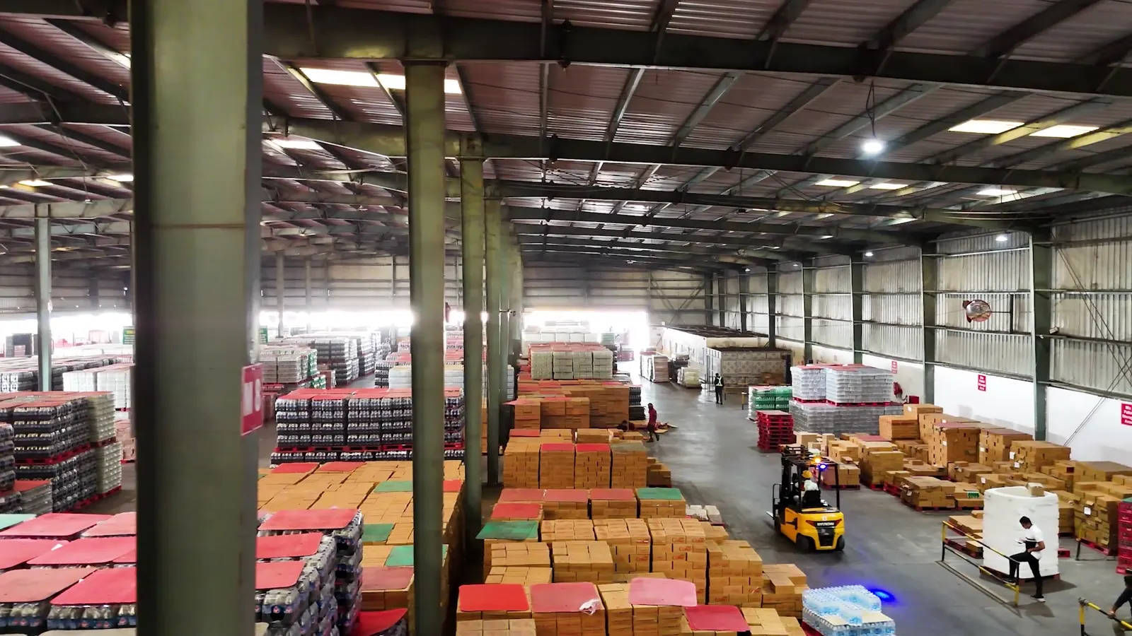 Stocked FMCG goods and forklift inside Patna warehouse